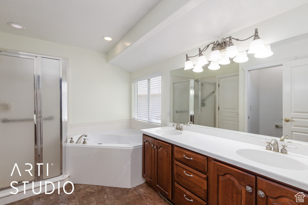 Full bath with a shower stall, double vanity, and a garden tub
