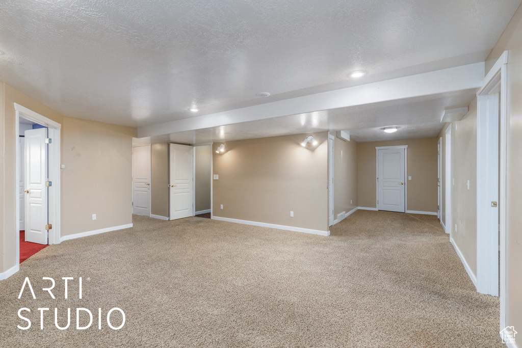 Basement featuring carpet floors and baseboards