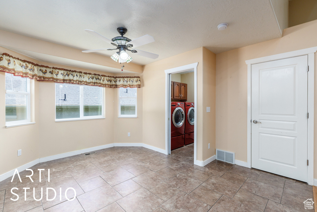 Unfurnished room with washer and clothes dryer, ceiling fan, and a smoke detector
