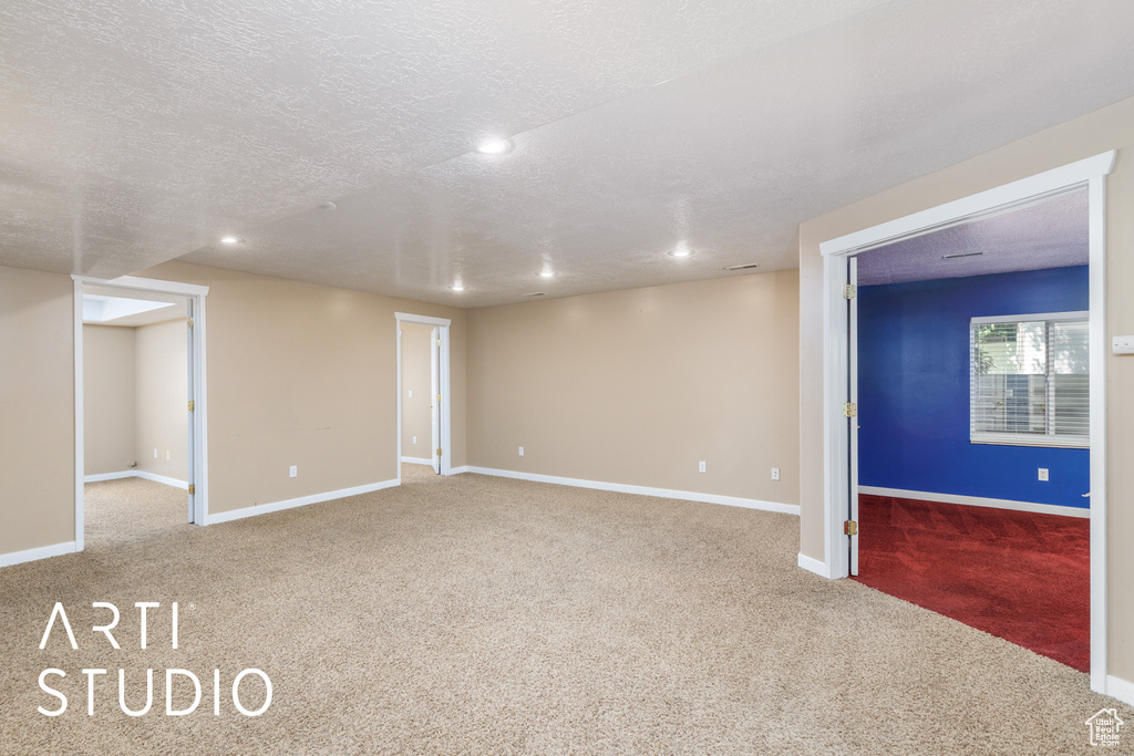 Carpeted empty room featuring recessed lighting and a textured ceiling