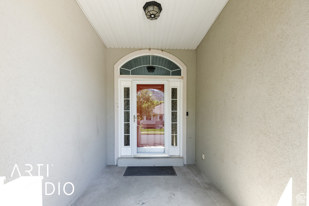 Entrance to property with stucco siding