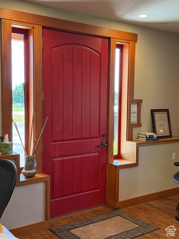 Foyer entrance with wood finished floors and recessed lighting