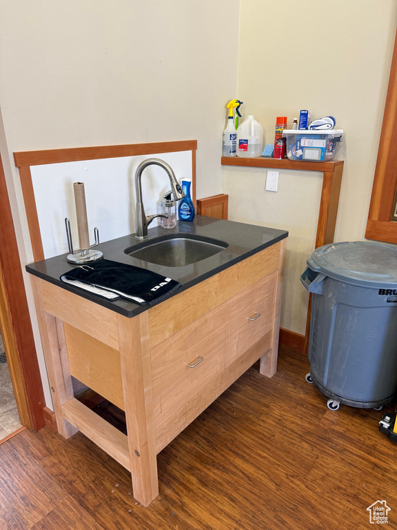 Kitchen with dark wood finished floors and dark countertops