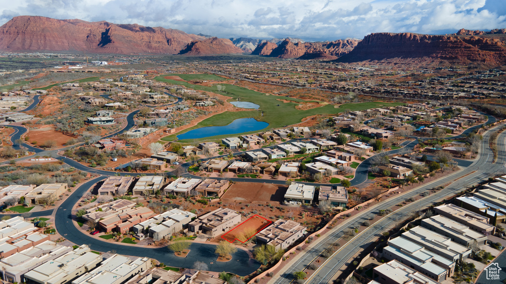 View of property location with a water and mountain view and nearby suburban area
