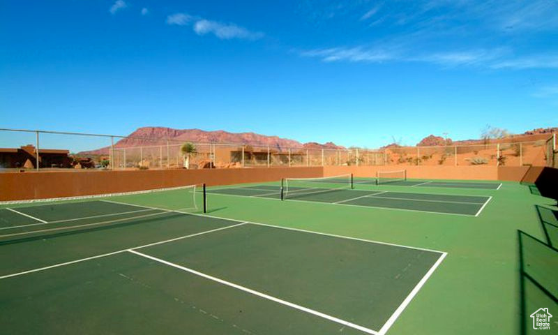 View of tennis court featuring community basketball court