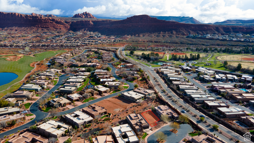Aerial overview of property's location featuring a water and mountain view and nearby suburban area