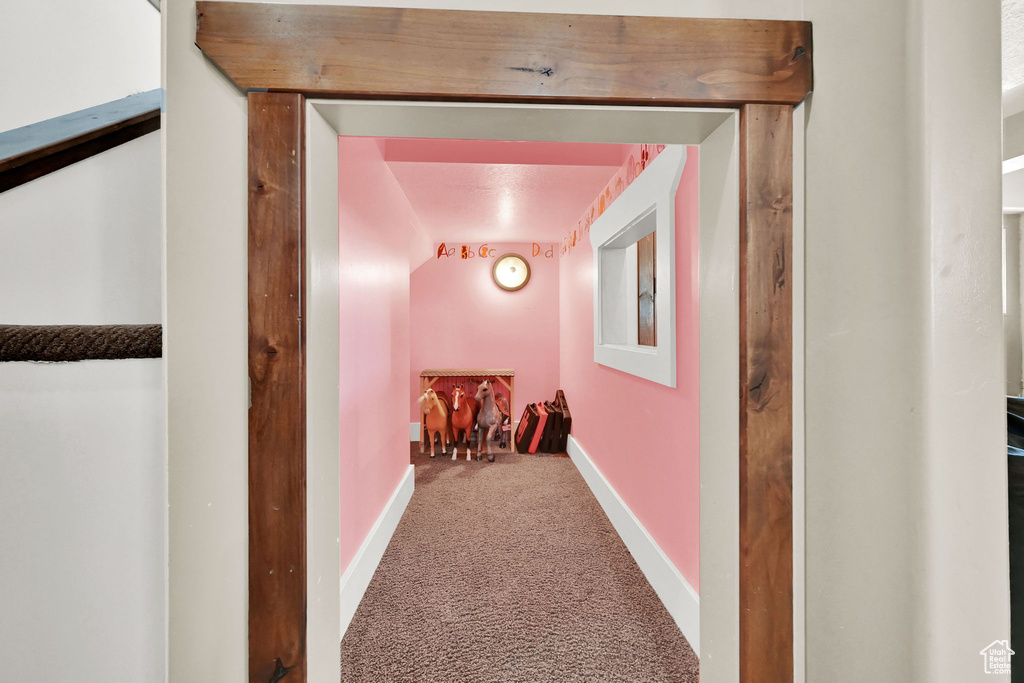 Hallway featuring carpet flooring
