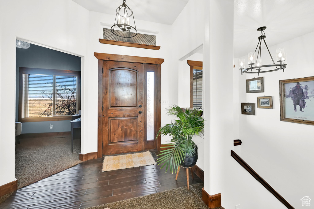 Entryway featuring wood-type flooring and an inviting chandelier