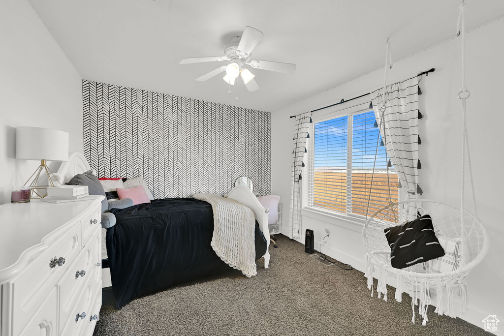 Carpeted bedroom with ceiling fan