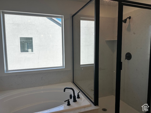 Bathroom with a garden tub and a shower stall