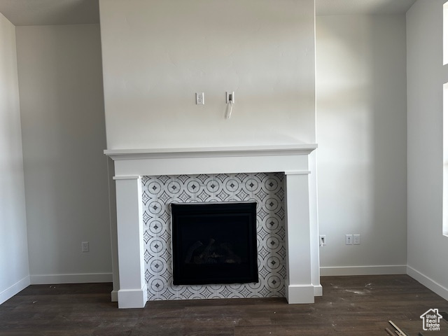 Detailed view of a fireplace and wood finished floors