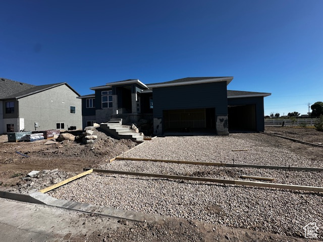 Prairie-style home featuring driveway and an attached garage