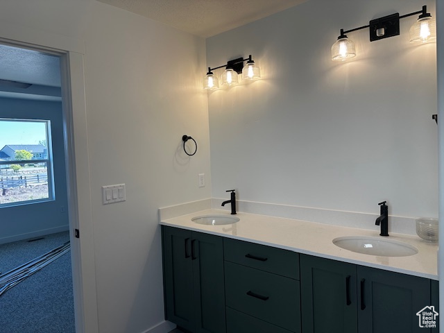 Bathroom with double vanity and baseboards