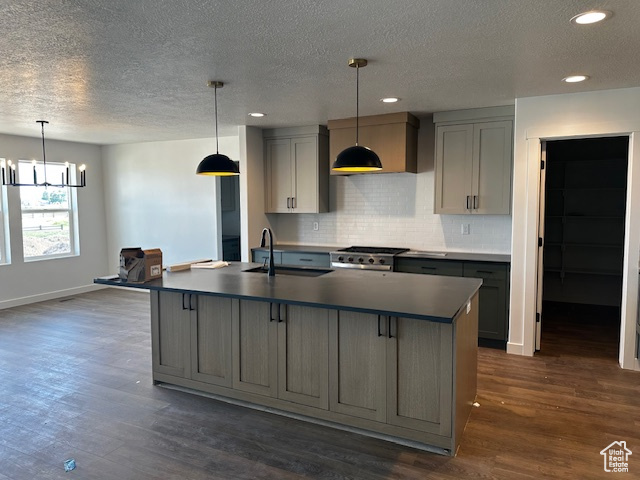 Kitchen with gray cabinetry, dark wood-style flooring, a textured ceiling, tasteful backsplash, and recessed lighting
