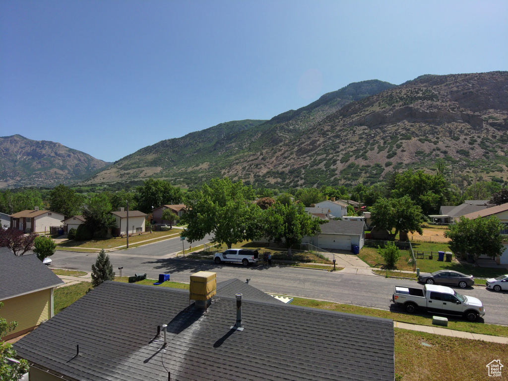 View of mountain backdrop featuring nearby suburban area