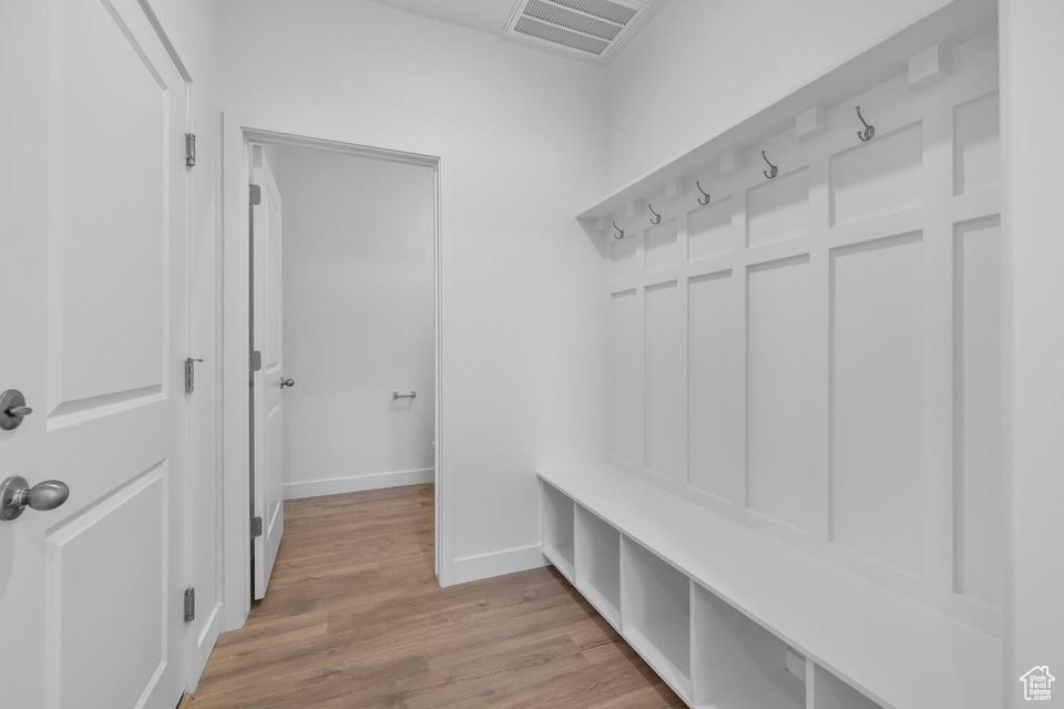 Mudroom featuring baseboards and light wood-type flooring