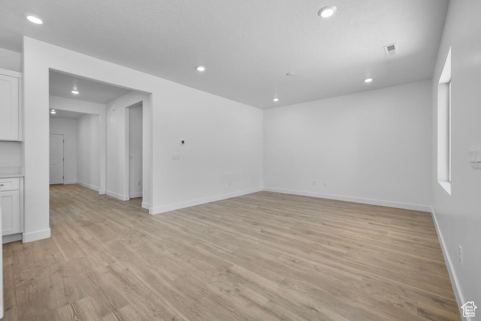 Unfurnished room with light wood-type flooring and recessed lighting
