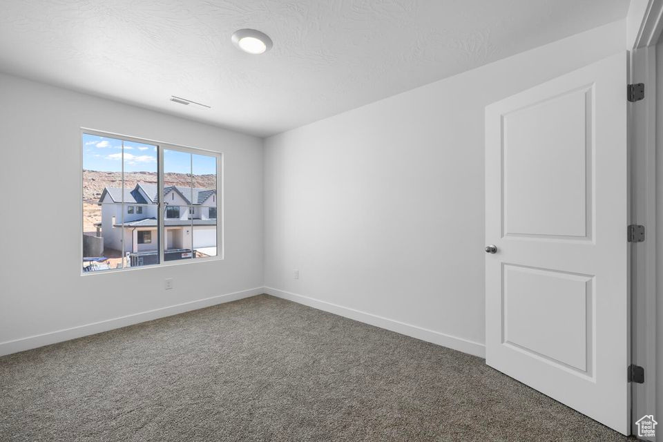 Spare room with carpet flooring