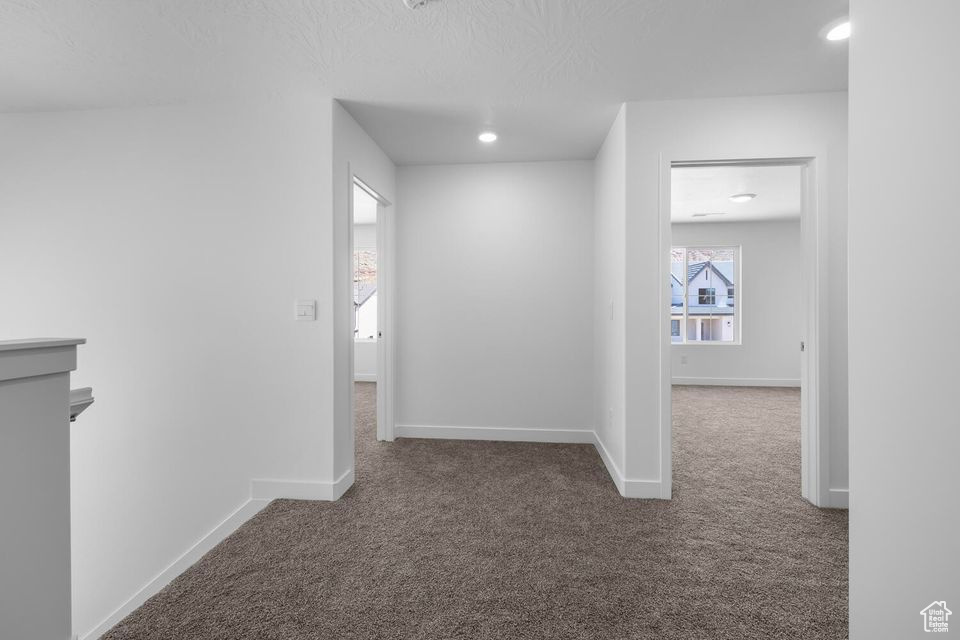 Hall with carpet floors and recessed lighting