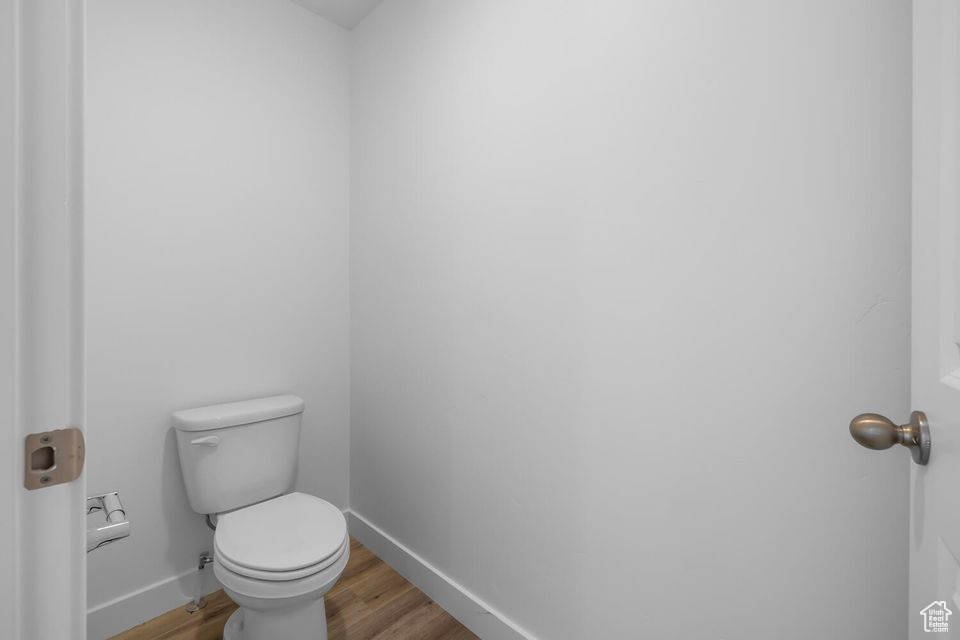Bathroom with wood finished floors and toilet