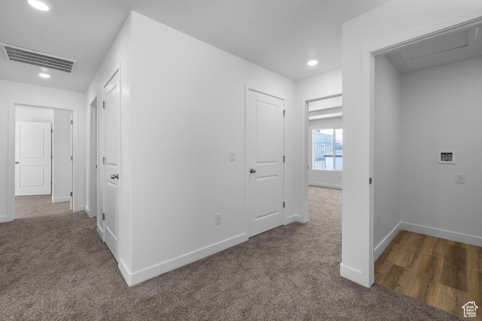 Hallway with carpet flooring and recessed lighting