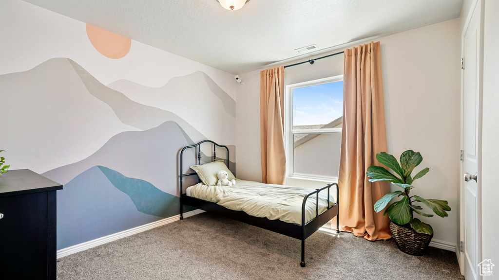 Bedroom featuring carpet floors and baseboards
