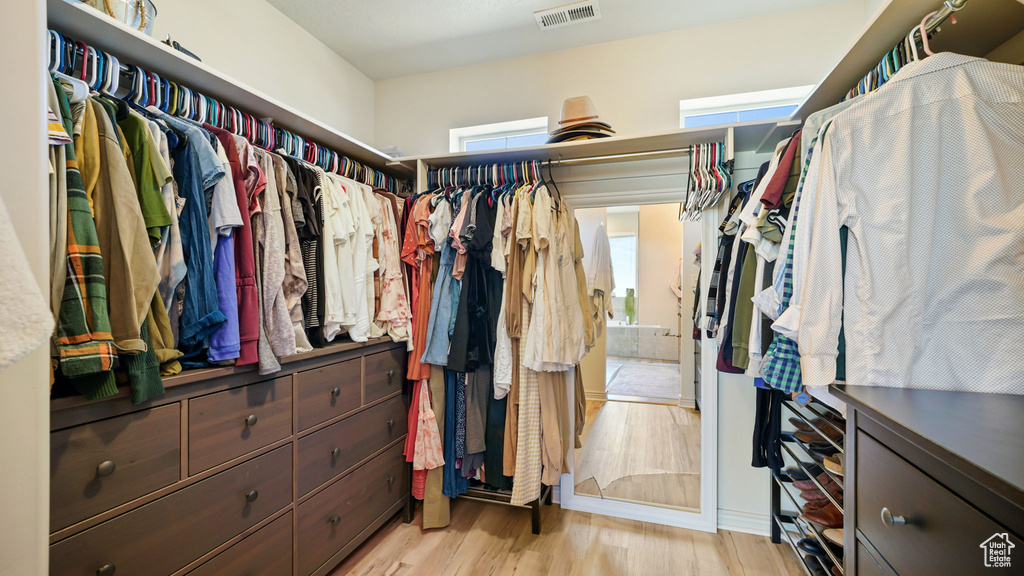 Spacious closet with light wood-style flooring