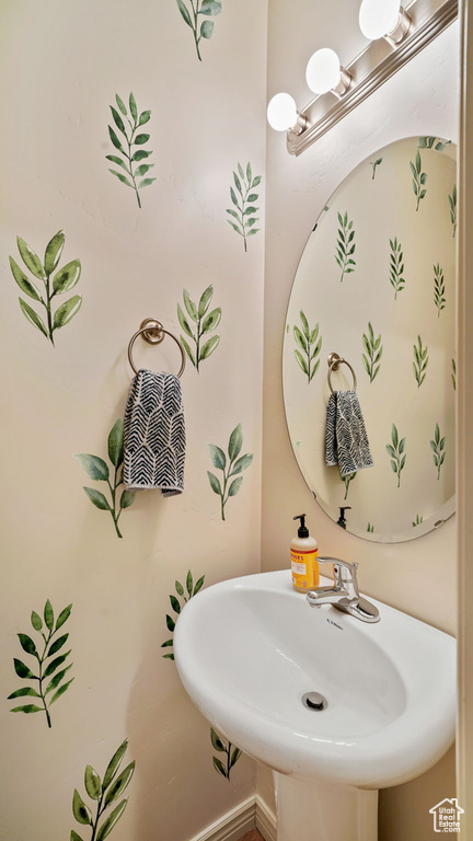 Bathroom with a sink and baseboards