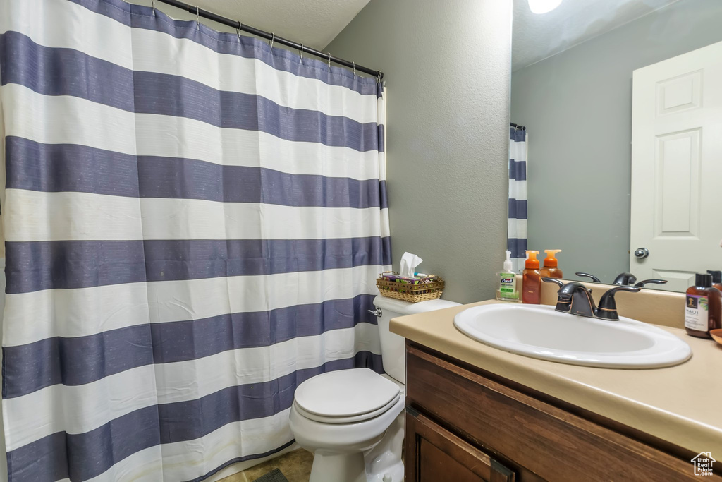 Full bathroom with vanity and a shower with curtain