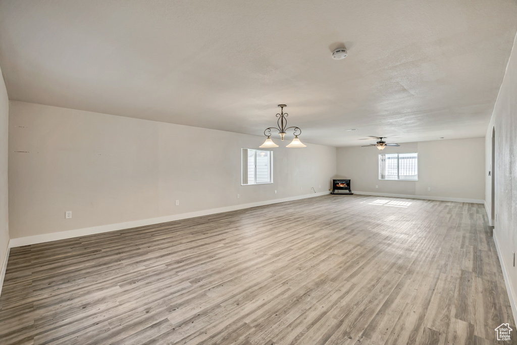 Unfurnished living room with ceiling fan and wood finished floors
