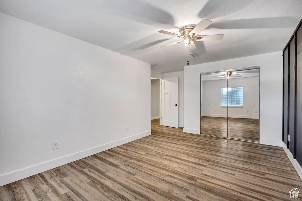Empty room featuring ceiling fan and wood finished floors
