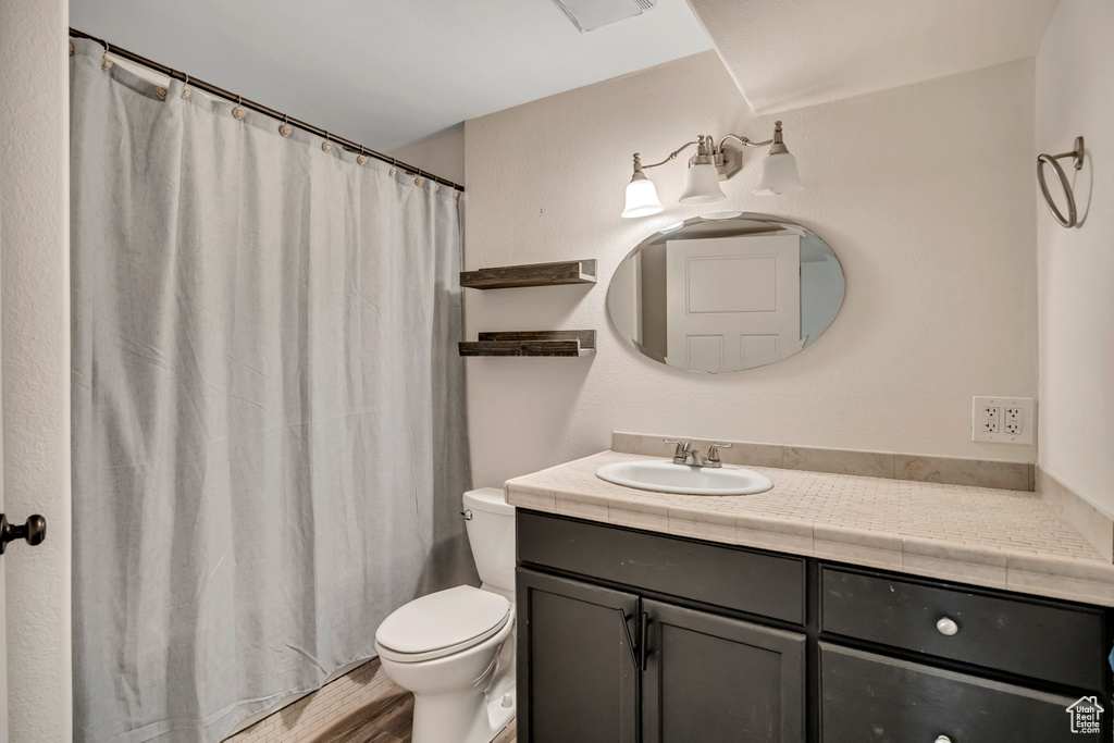 Bathroom with vanity and curtained shower