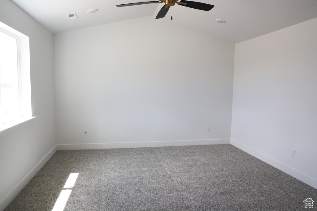 Unfurnished room with a ceiling fan, carpet, and lofted ceiling