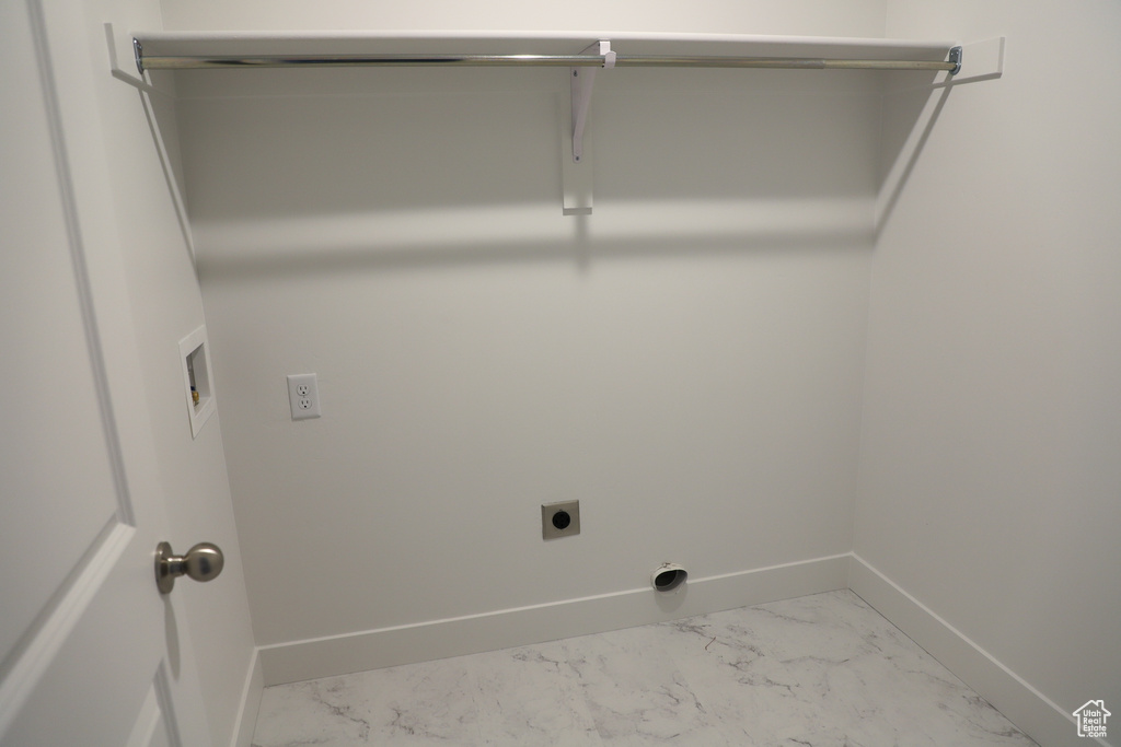 Washroom with hookup for an electric dryer, marble look tiles, and washer hookup