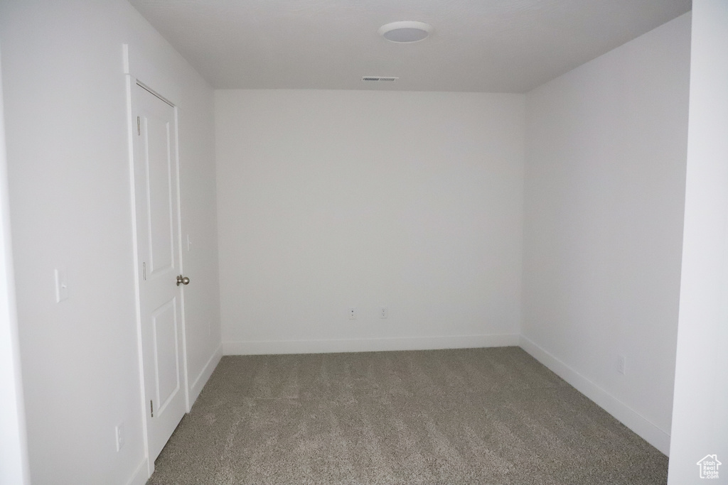 Carpeted empty room featuring baseboards