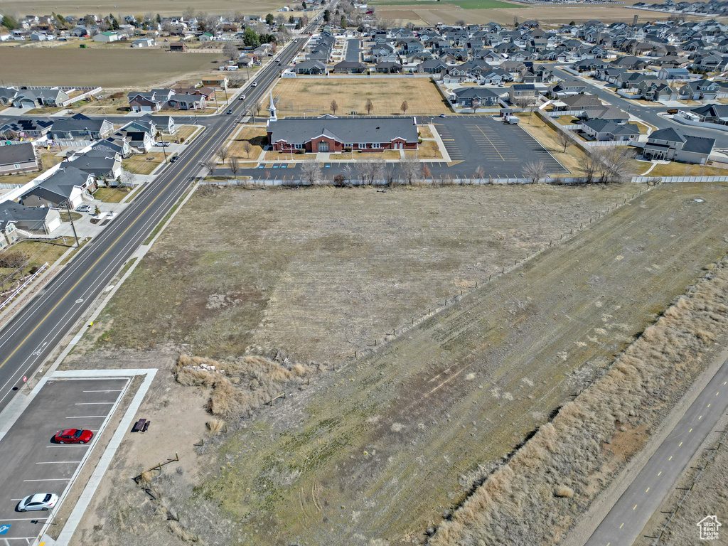 Aerial view of property and surrounding area with nearby suburban area