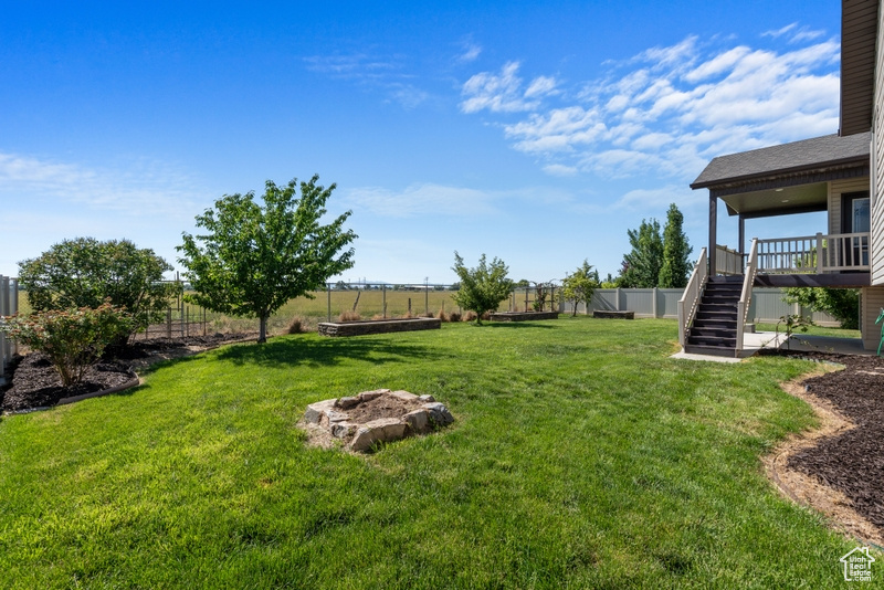 Fenced backyard featuring stairway