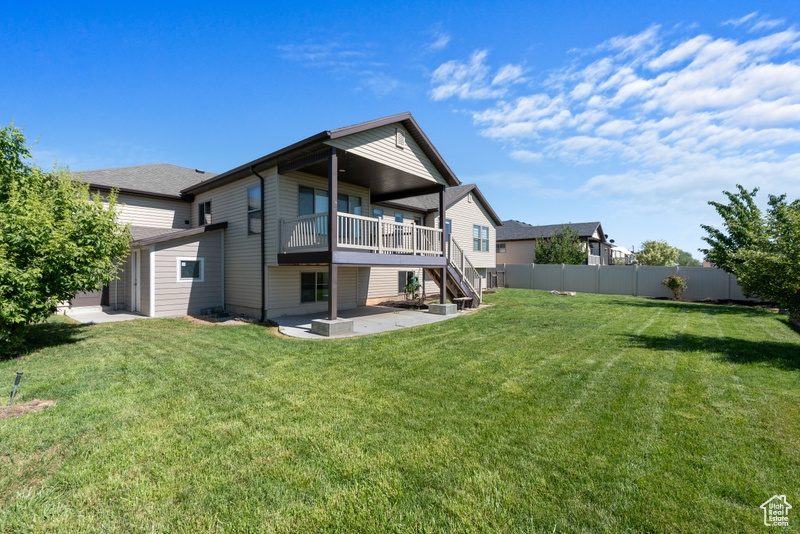 Back of property with a patio area, stairs, and a wooden deck