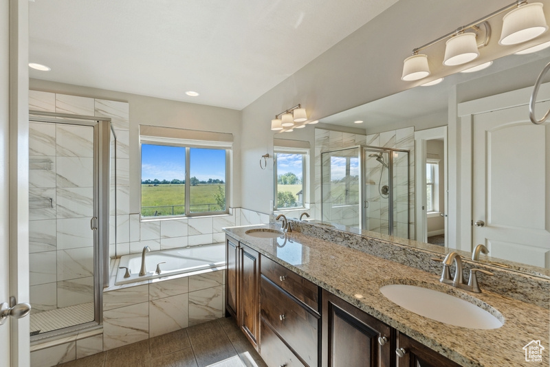 Full bath with a bath, a stall shower, double vanity, recessed lighting, and tile patterned flooring