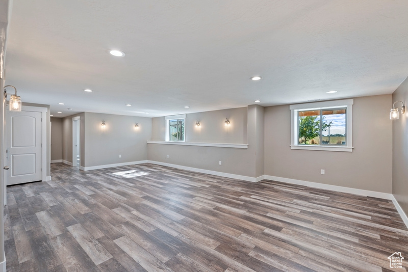 Basement featuring recessed lighting, wood finished floors, and healthy amount of natural light