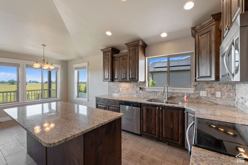 Kitchen with appliances with stainless steel finishes, tasteful backsplash, healthy amount of natural light, a chandelier, and recessed lighting
