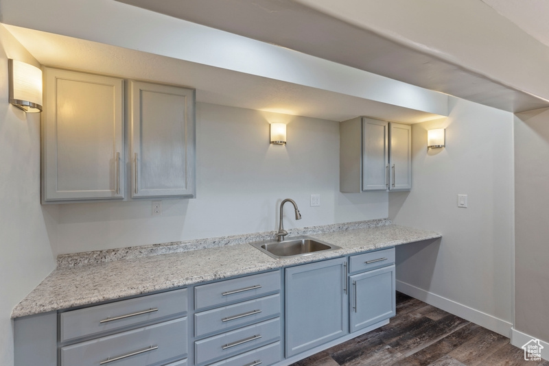 Kitchen with dark wood-style floors, light countertops, and gray cabinets