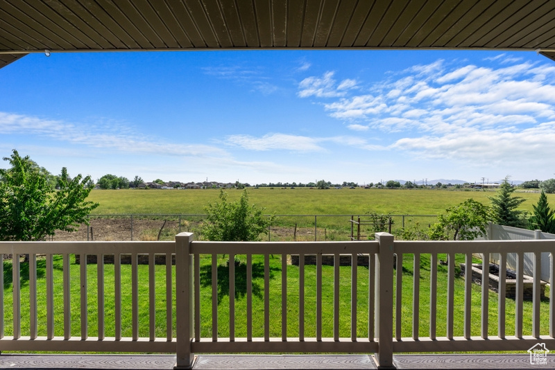 Deck with a rural view and a fenced backyard