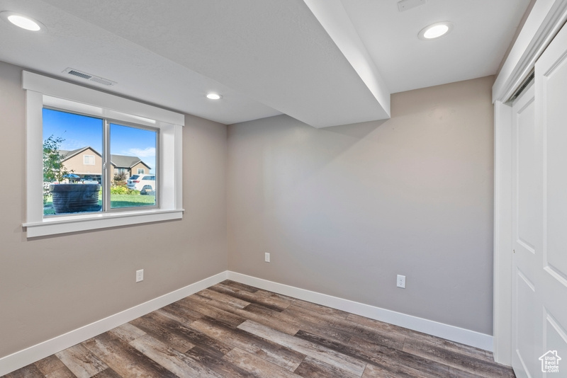 Unfurnished bedroom with wood finished floors and recessed lighting