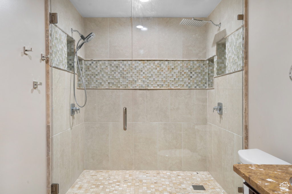 Bathroom featuring a stall shower and vanity