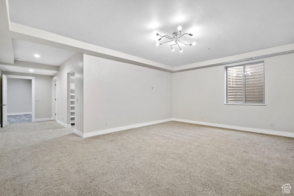 Carpeted spare room with baseboards and recessed lighting