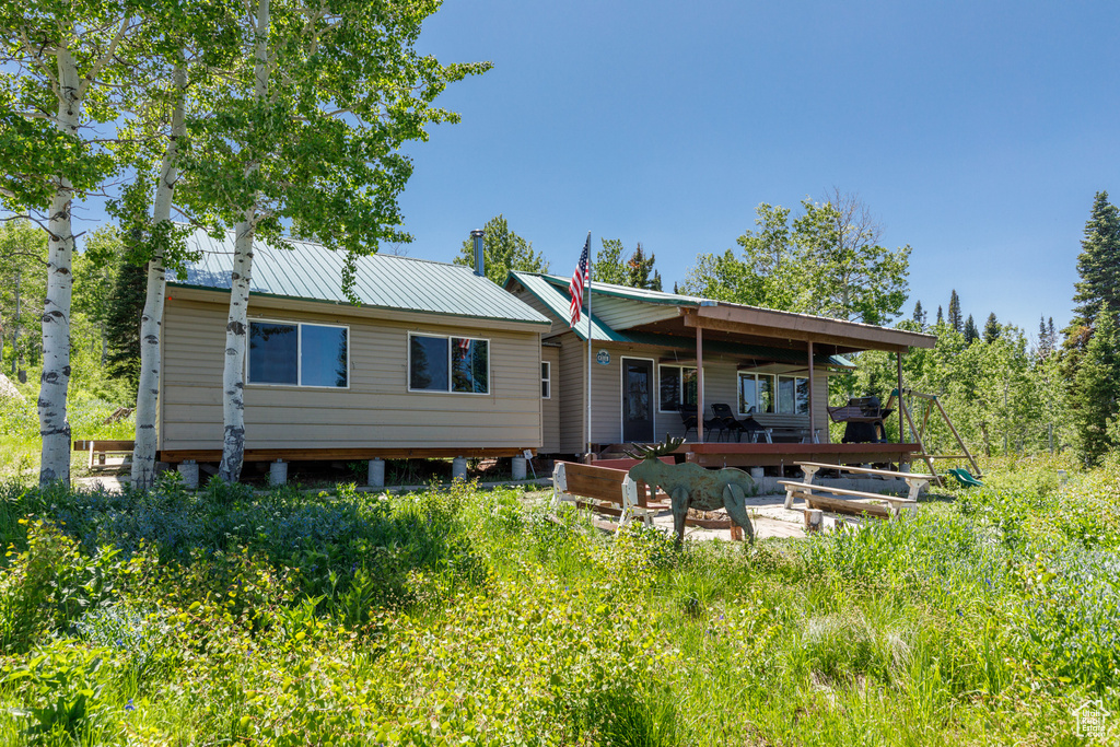 Back of property featuring a metal roof
