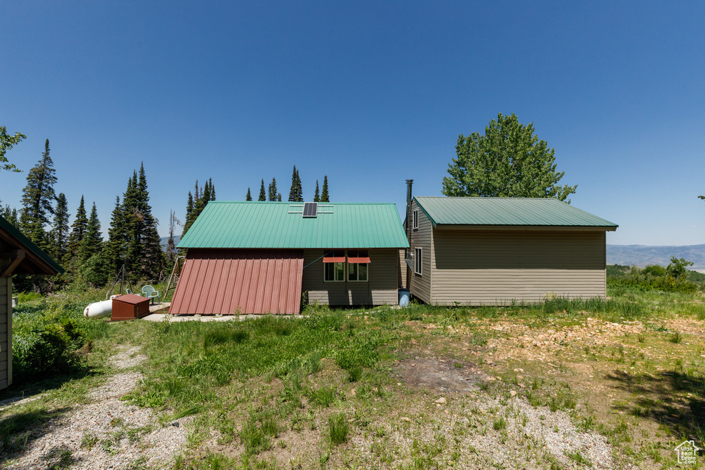 Back of property with a metal roof