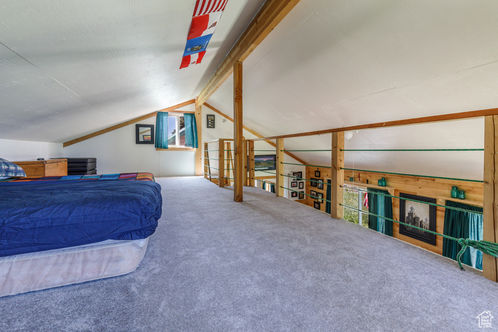 Bedroom featuring vaulted ceiling and carpet floors