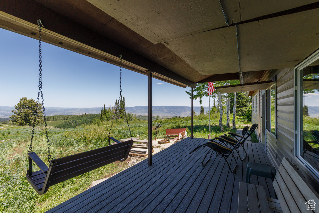 Wooden terrace featuring a mountain view